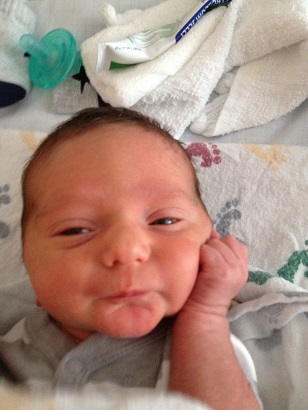 Julie from MD: Her little man at 1 day old . . . already putting on the charm for the ladies!
